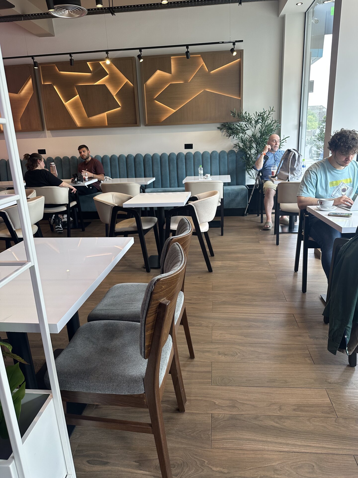 Bakery seating area with banquettes and wood-panel feature wall
